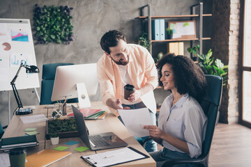 Photo of professional man lady discuss papers working together colleagues coworking successful businesspeople nice light office