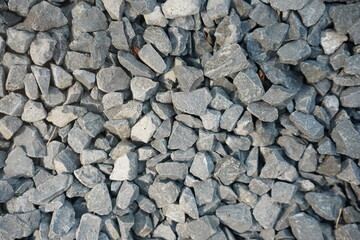 Natural gray pebbles background with various shapes.