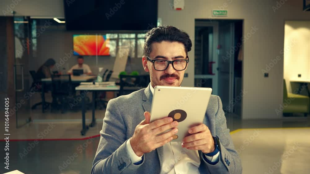 Aufkleber business professional using a tablet in a modern office environment while collaborating with colleag
