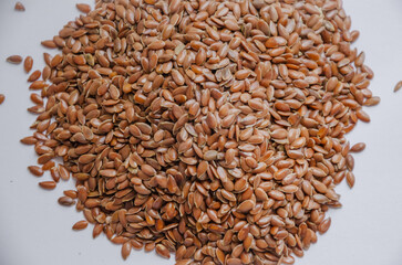 brown flax seeds on a light background