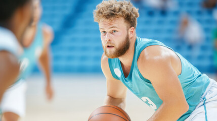 Young athlete playing basketball with focus and determination wearing blue sports jersey on an indoor court surrounded by teammates
