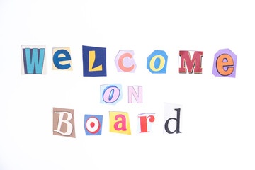 Welcome symbol. Concept words Welcome on Board isolated on clean white background in fun cut out newspaper style typescript. 