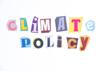 Phrase Climate Policy spelled in cut out newspaper style typography isolated on white background.