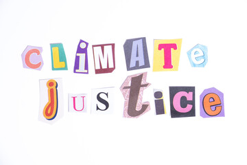 Phrase Climate Justice spelled in cut out newspaper style typography isolated on white background.