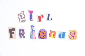 Phrase Girl Friends spelled in cut out newspaper style typography isolated on white background.