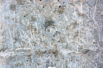 Original background, building materials, gray cement walls covered with light brush strokes with white paint.