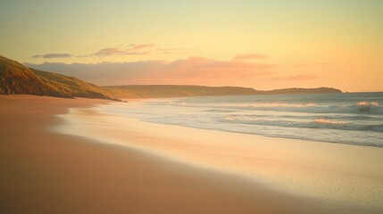 A tranquil beach at sunset, with soft waves lapping against the smooth golden sand and the sky glowing in shades of orange and pink