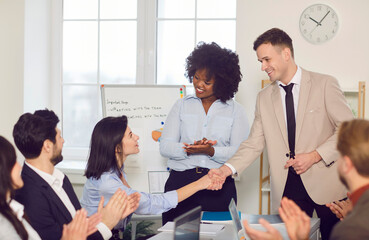 Businesspeople meeting represent, diverse workers support new employee, staff sitting at desk clap...
