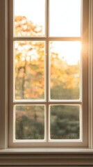 A sunlit window with a view of autumn foliage in soft focus.