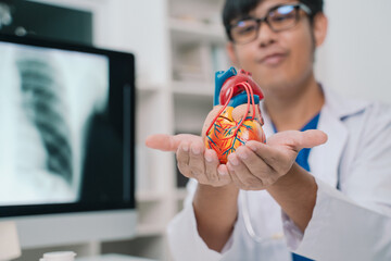 At the hospital, the cardiologist reviewed the anatomy of the heart with the patient, explaining...