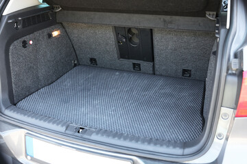 Grey rubber car boot liner mat in trunk of auto