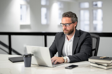 Modern office. Successful caucasian business man in business suit using laptop, working remotely, e-commerce online at office. Finance auditor. Ceo manager employee having business idea. Business