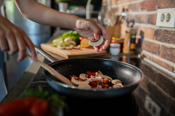 Young woman preparing fresh vegetables in a modern kitchen