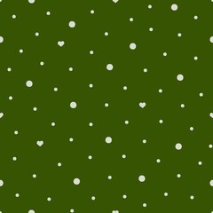 Big, small white balls and hearts on a green background