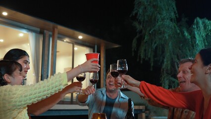 Family together for holiday celebration. Adult member hold grape wine in glass except daughter....