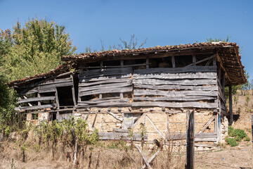 Old wooden weathered rural farm barn closeup on sunny summer day