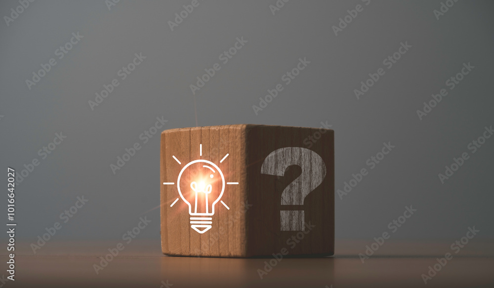 Poster glowing lightbulb on bright side and question mark on dark side of wooden block cube for problem sol