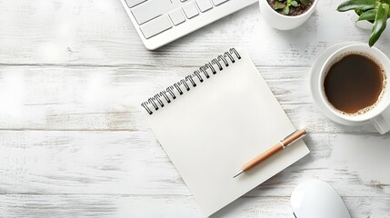 A top down view of a minimalist desk setup with a notebook pen coffee cup and small plant on a wooden surface in soft natural tones creating a calm and focused workspace