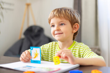 Young boy learning with flashcards at home