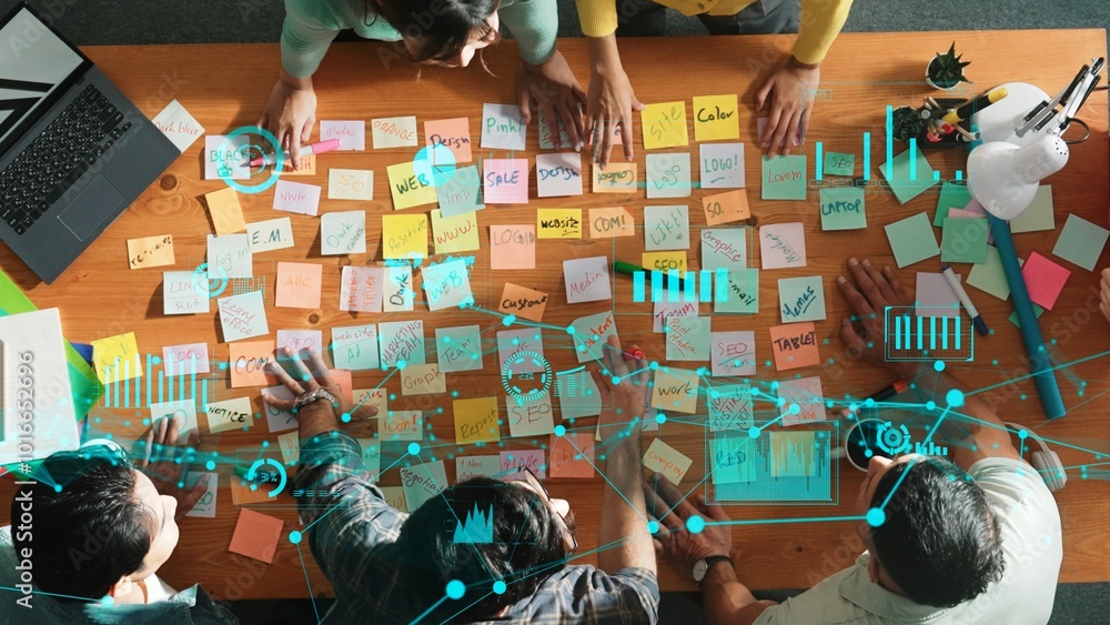 Aufkleber top down view of business team with casual outfit looking laptop screen and sharing idea. aerial vie