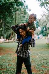 Father and son playing together, capturing a moment of joy and bonding.