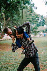 Fototapeta premium Father and son playing together, capturing a moment of joy and bonding.