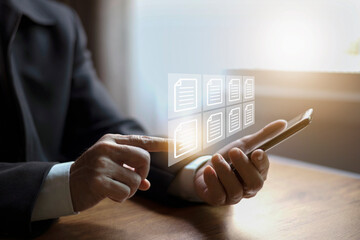 E-document management Paperless workplace, Businessman touching on document for online approve paperless quality assurance and ERP management..online documentation database, paperless office concept.