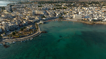 Fototapeta premium Aerial view Porto Cesareo promenade. It is a small city on the Mediterranean Sea in the province of Lecce in Puglia, Italy. It is a tourist town located on the Ionian coast of the Salento peninsula.