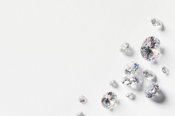 Many beautiful shiny diamonds on white background, flat lay. Space for text