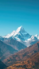 Majestic snow-capped mountain peaks under a clear blue sky, showcasing the beauty of nature and adventure in the wilderness.