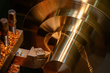 The lathe machine finish cut the brass material parts by lathe tools.