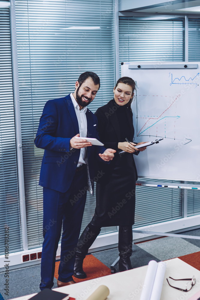 Poster professional economists enjoying break from working with graphics on flip chart watching funny video