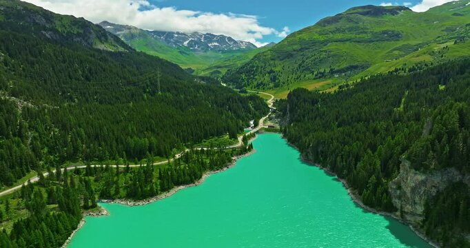 Water transport in Switzerland. Navigating a Swiss Lake. Aerial view steamboat ship on lake Interlaken. Switzerland summer tourism destination. Turquoise blue water. Swiss flag on a passenger ship