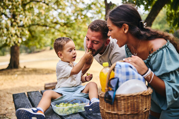 Child Feeds Parents In Nature