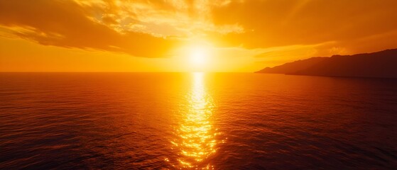 Fototapeta premium Stunning golden sunset casts a warm vibrant glow over the vast tranquil ocean creating a breathtaking and serene natural landscape
