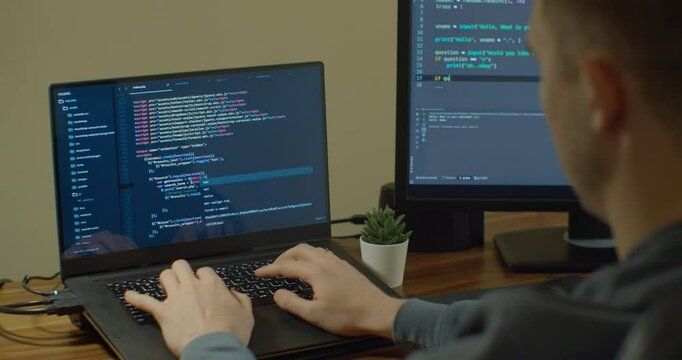 Closeup coding on screen, Man hands coding html and programming on screen Monitors, development web, developer.