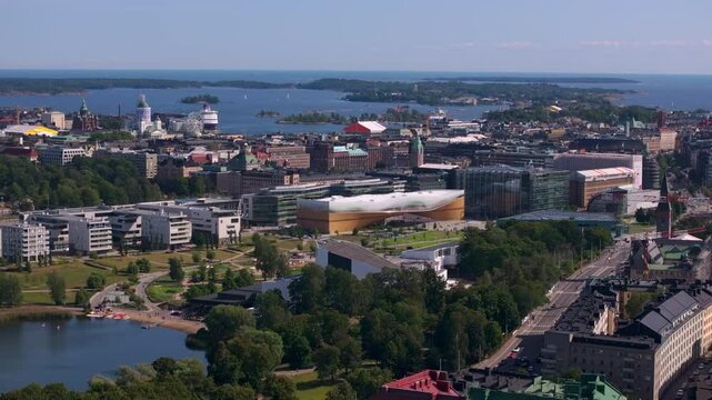 Helsinki city center features lush parks and the Baltic Sea, creating a vibrant urban scene rich in architectural landmarks including Central Library Oodi