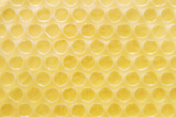Yellow bubble wrap texture close up as background