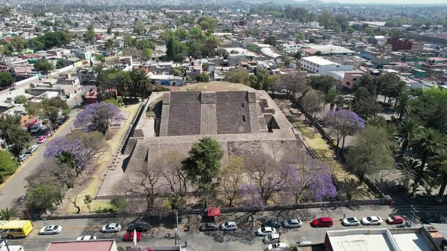 Drone flight over Tenayuca Archaeological Site, Mexico. Pyramid in the middle of the city