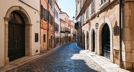 Narrow cobblestone street with historic buildings and archways
