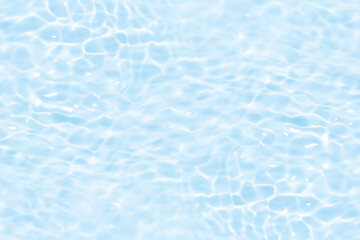 Blue water with ripples on the surface. Defocus blurred transparent blue colored clear calm water surface texture with splashes and bubbles. Water waves with shining pattern texture background.