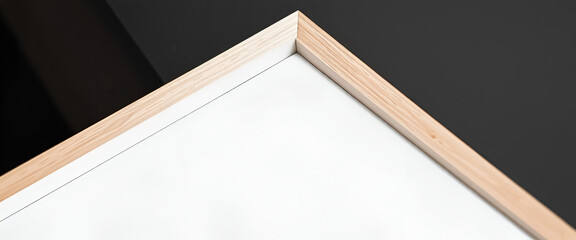 Fototapeta premium Close-up angle of a wooden picture frame, highlighting craftsmanship and minimalist design, perfect for mockup use. Black background.