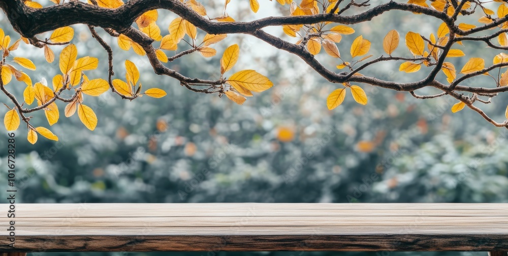Poster a beautiful autumn background with golden maple branches over an empty wooden table and copy space f