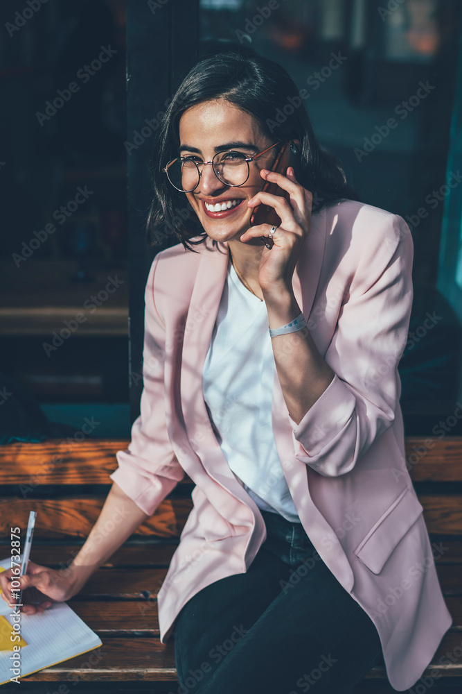 Poster portrait of cheerful georgian woman in stylish spectacles smiling at camera planning schedule while 