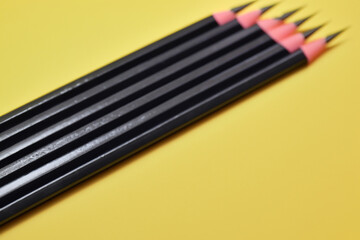 Man is drawing and yellow with pencils. pencil white education concept. a and white pencils lying on a yellow . a man is lying on a white with yellow pencils lifestyle.