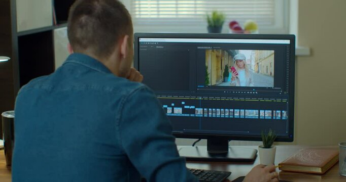 post production and vlog concept - man working in video editor program on laptop computer at home office.