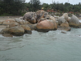 Bangka. Belitung. Bali. Indonesia. Beautiful beach view with large rocks, white sandy beach and rocky formations against bright blue sky, rugged nature