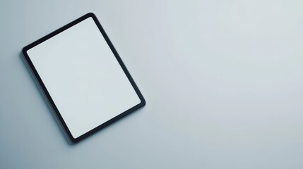 Fototapeta premium Minimalistic image of a blank tablet on a light surface, emphasizing technology and sleek design. Perfect for business and tech concepts.