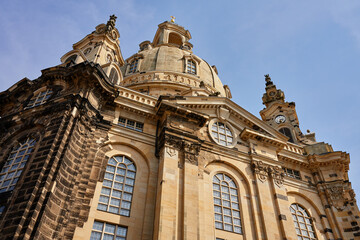 Buiilding exterior of Dresden Frauenkirche. Baroque architecture with stonework, large arched...