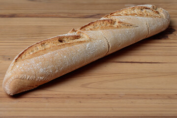 Loaf of bread resting on wooden tabletop